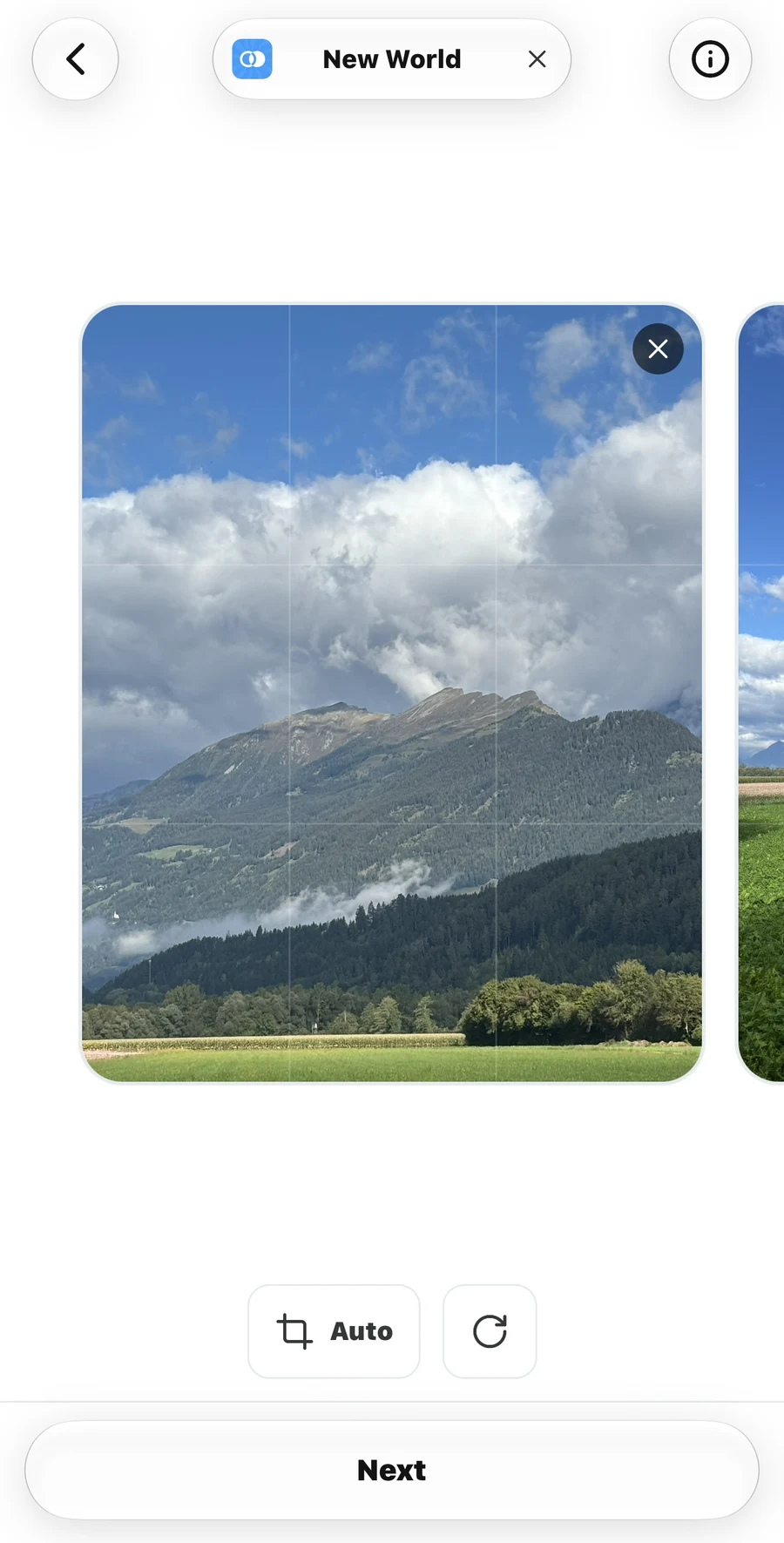 Photo editing screen showing a mountain image, its remove button, the Auto crop control, rotate button, and Next button.