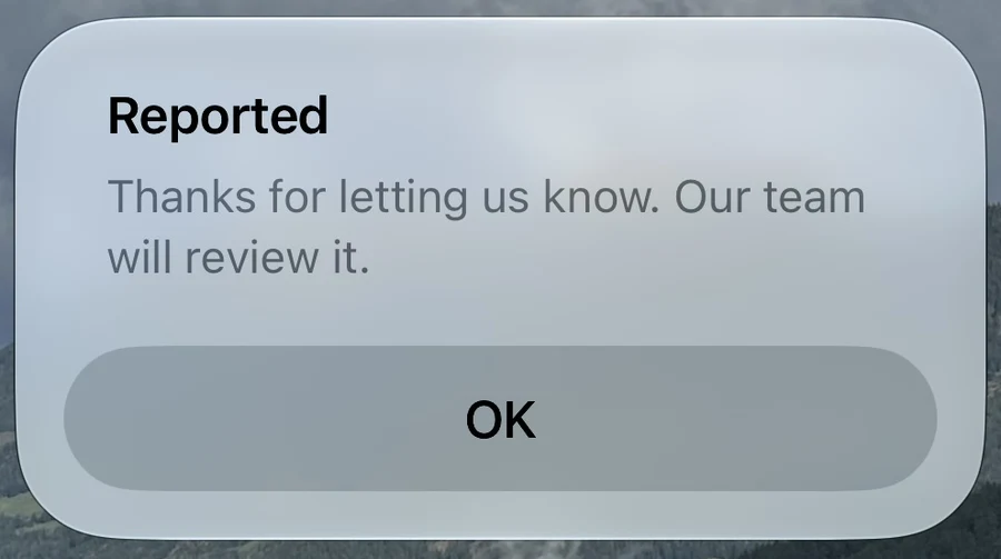 Reported confirmation stating Thanks for letting us know. Our team will review it. with an OK button.
